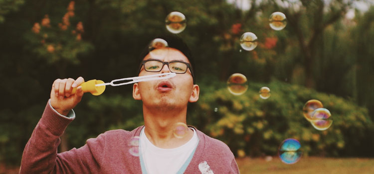 boy blowing bubbles