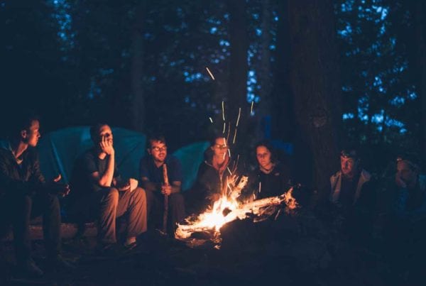 people sitting around a campfire telling stories