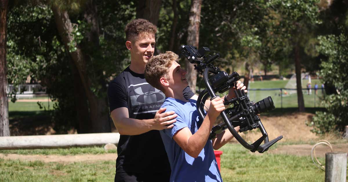 videographer and kid taking great summer camp videos