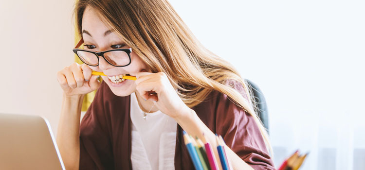 frustrated woman biting a pencil
