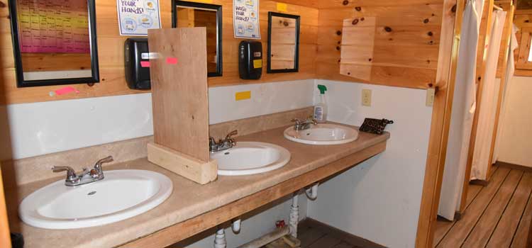 a camp bathroom with sinks separated at a camp that stayed open in 2020