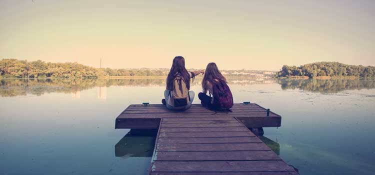 camp counselors sitting at a lake
