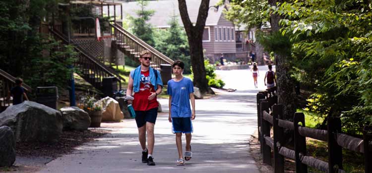 two people walking on a path together as an example of summer camp photography